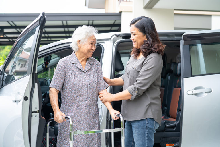 Asian senior woman patient sitting on walker prepare get to her car, healthy strong medical concept.